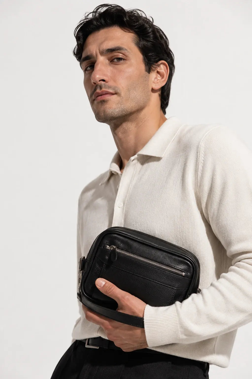 Male model carrying a black leather bag